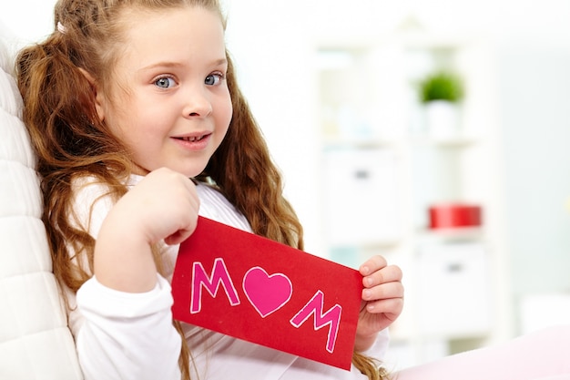 Cheerful girl holding a red envelope