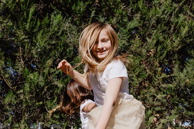 Cheerful girl jumping near trees