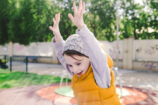 Cheerful girl jumping on playground