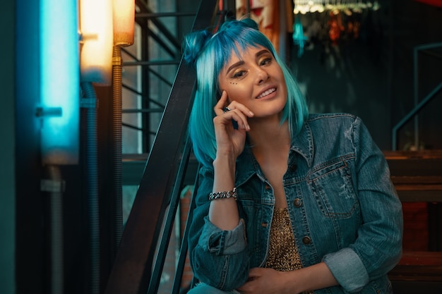 Cheerful girl portrait with stylish blue hair and pretty face