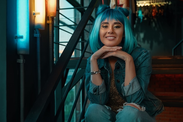 Cheerful girl portrait with stylish blue hair and pretty face