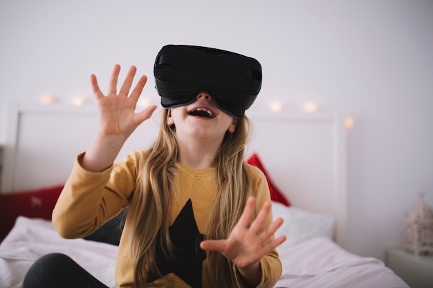 Cheerful girl in VR glasses