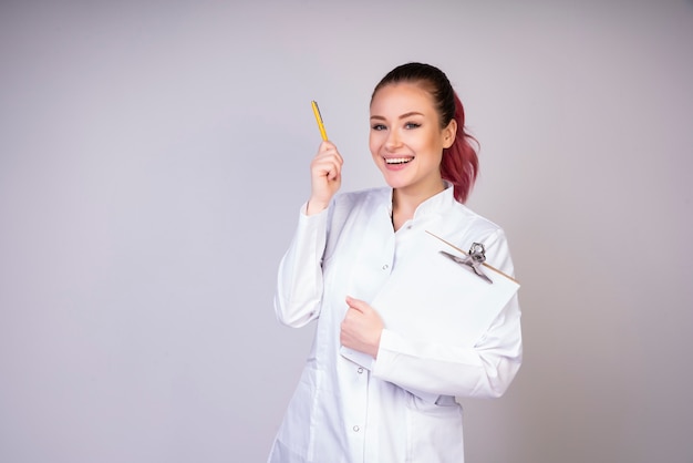 Cheerful girl in white doctor uniform