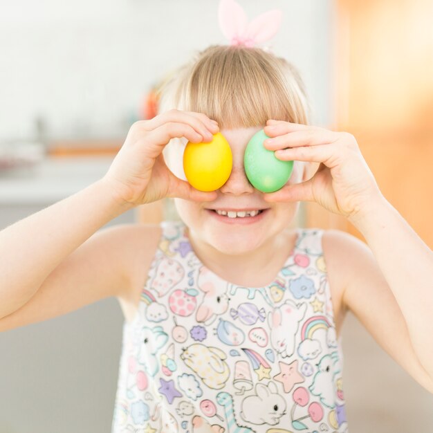 Cheerful girl with painted eggs