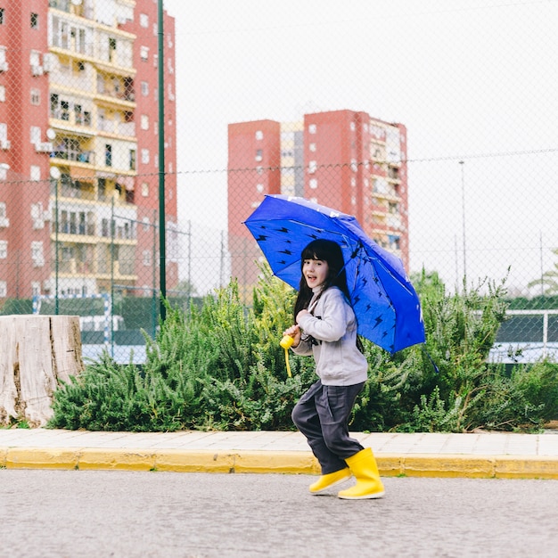 Free photo cheerful girl with umbrella