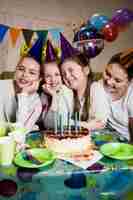 Free photo cheerful girls near nice cake