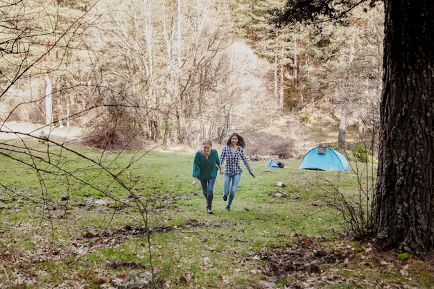 Cheerful girls running in the field