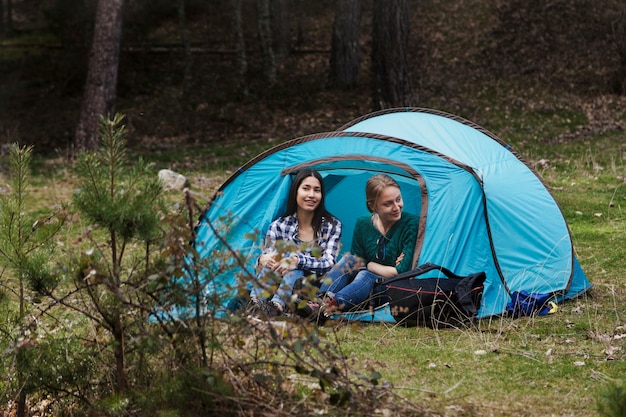 Cheerful girls spending the afternoon in a tent