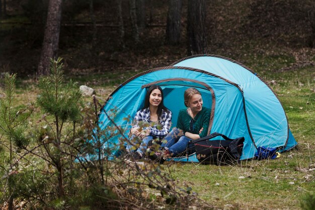 Cheerful girls spending the afternoon in a tent