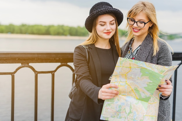 Cheerful girls with map