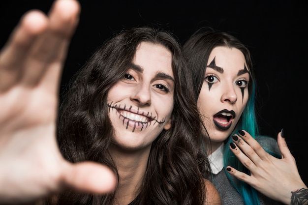 Cheerful girls with spooky makeup