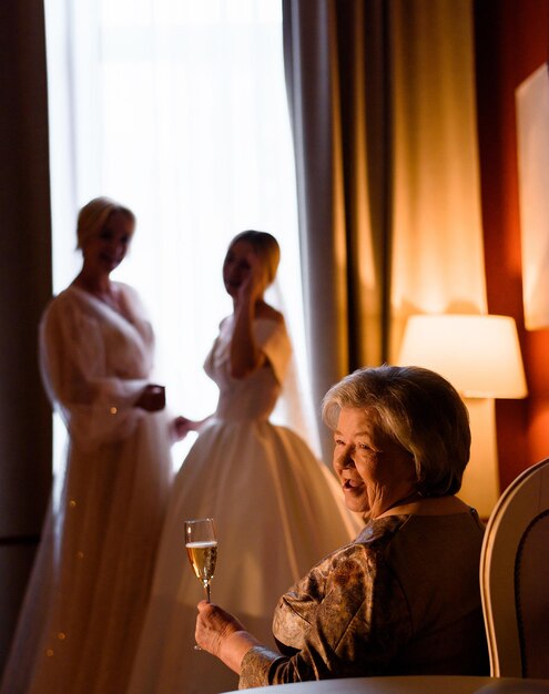 Cheerful Grandma Enjoying Of Her Granddaughter In Wedding Dress