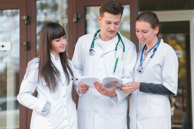 Cheerful group of medics reading papers