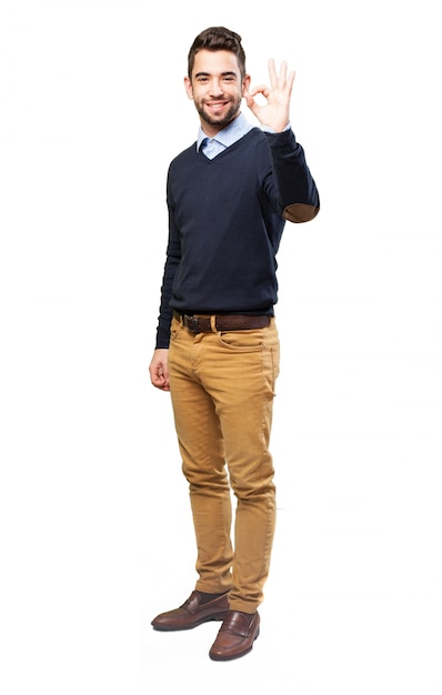 Cheerful guy gesturing with his left hand