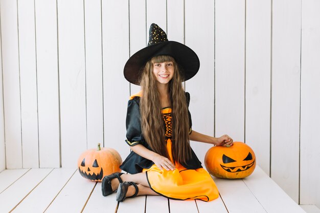 Cheerful Halloween witch with Jack-O-Lanterns