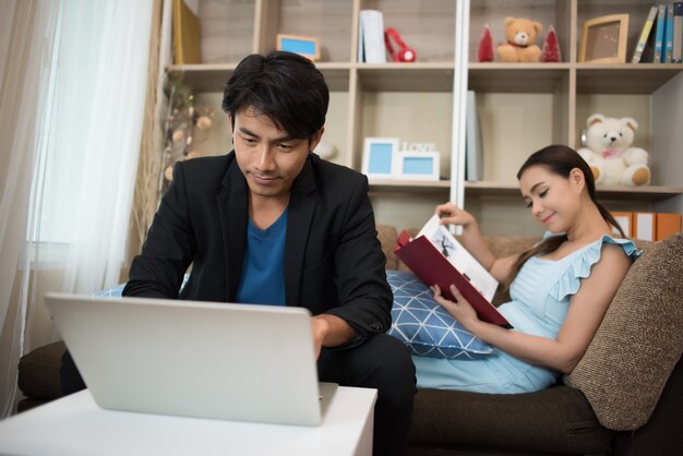 Cheerful Happy couple relaxing in sofa at home