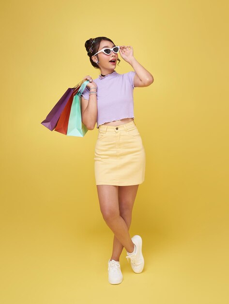 Cheerful happy thai asian woman enjoying shopping she is carrying shopping bags