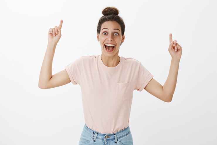 Free Photo cheerful happy young stylish woman posing against the white wall