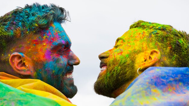 Cheerful homosexual pair looking at each other