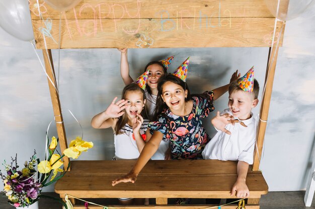 Cheerful kids near birthday stall