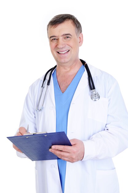 Cheerful laughing mature male doctor writing down some information