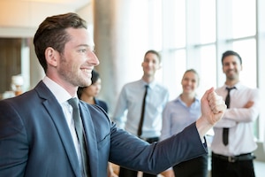 Cheerful leader motivating his business team