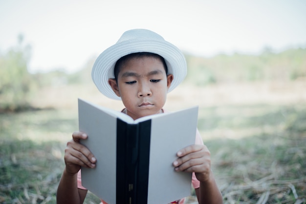 Cheerful Little Boy Reading Book