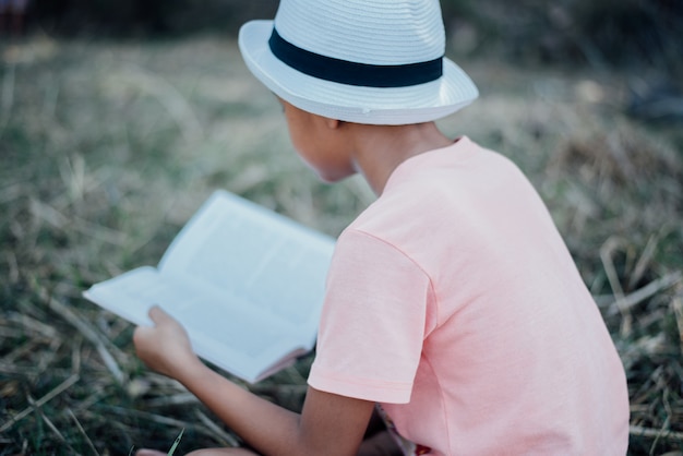 Cheerful Little Boy Reading Book