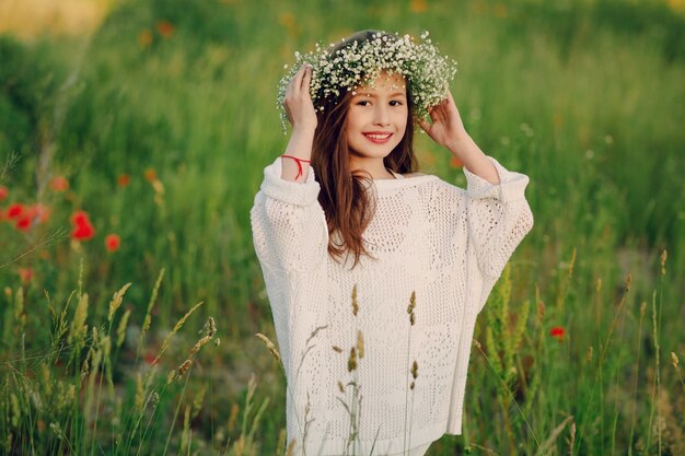 Cheerful little girl with a wreath on her head