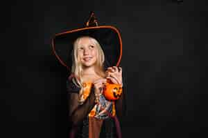 Free photo cheerful little witch with plastic bucket