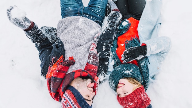 Cheerful loving couple having fun in snow