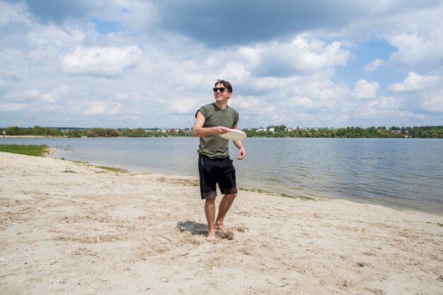 Cheerful male playing with flying disc 