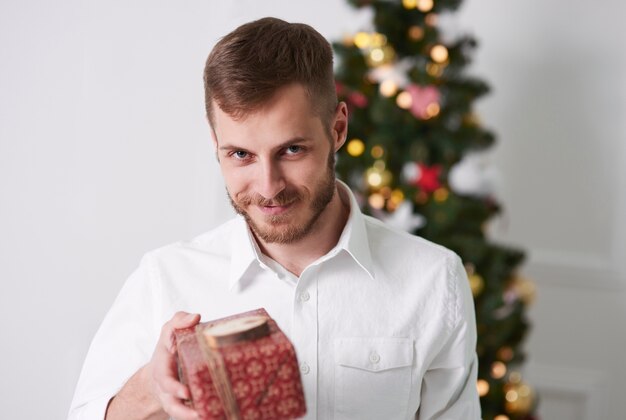 Cheerful man giving a gift