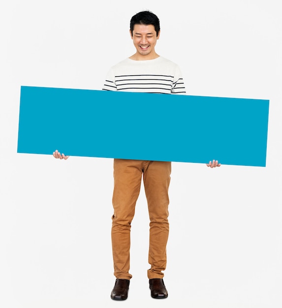 Cheerful man holding a blank blue banner