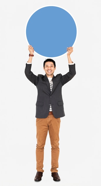 Free photo cheerful man holding a blank blue circle