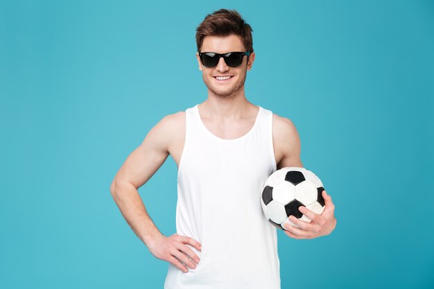 Free photo cheerful man holding foot ball