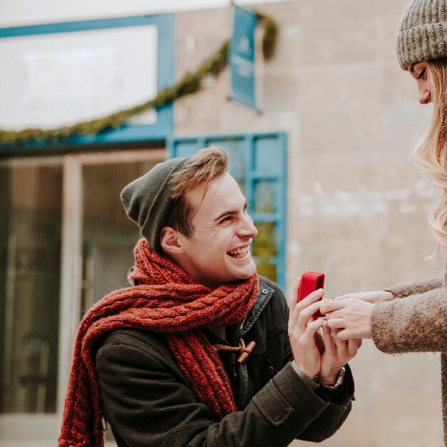 Cheerful man proposing to girlfriend