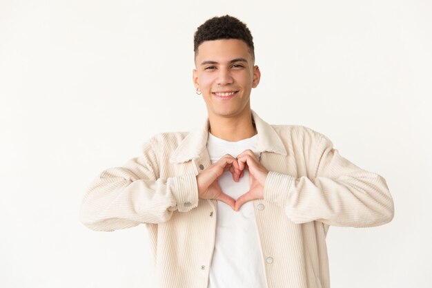 Cheerful man showing hand heart symbol