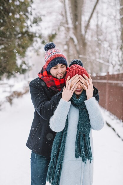 Cheerful man surprising young girl on date