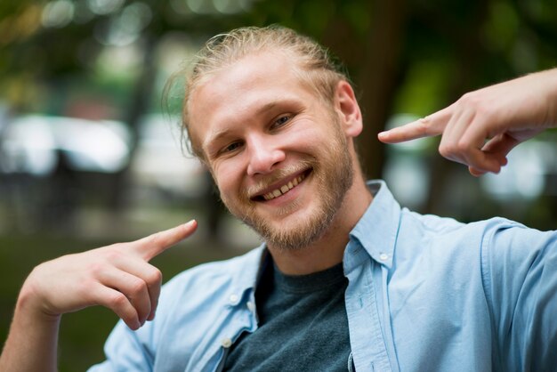 Cheerful man telling you to smile