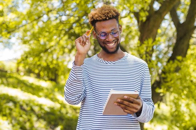 Cheerful man thinking on writing