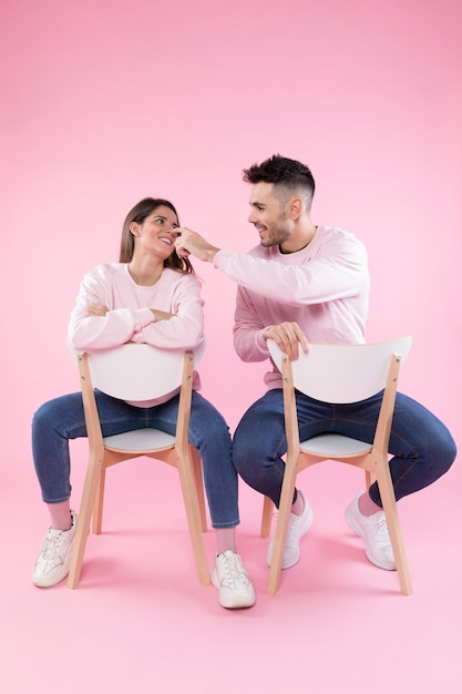 Cheerful man touching nose of girlfriend