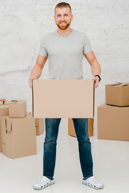 Cheerful man with carton box