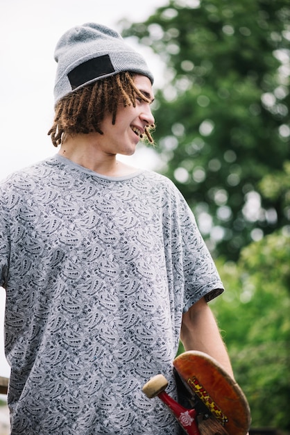 Free photo cheerful man with skateboard