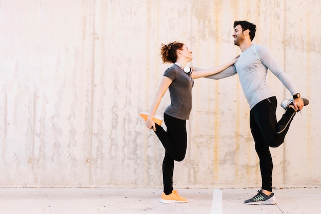 Cheerful man and woman exercising together