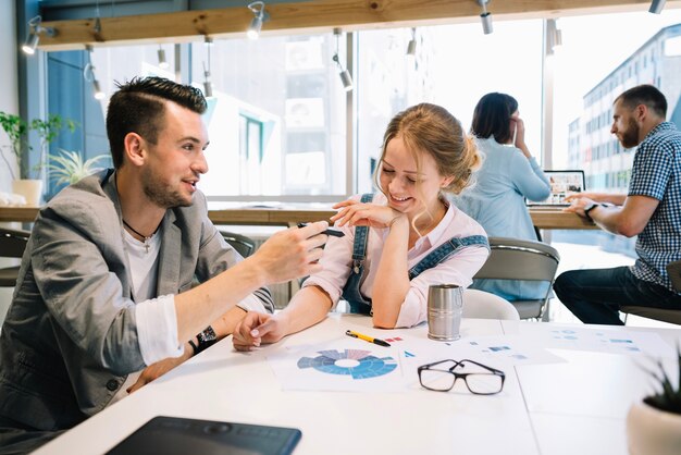 Cheerful man and woman in office