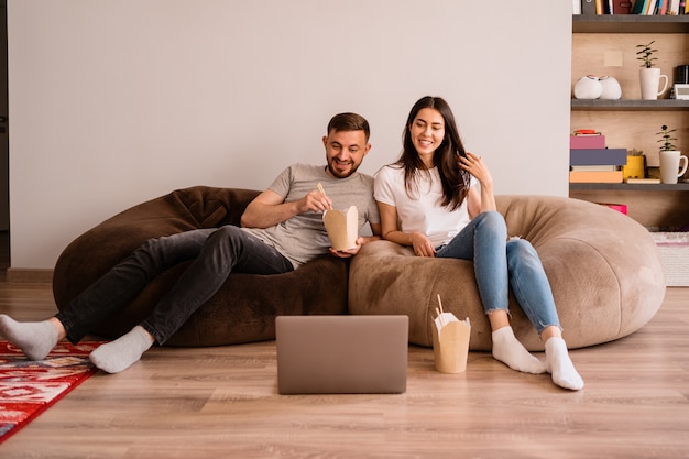 A cheerful man and woman spend good time together at home