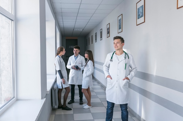 Free photo cheerful medic standing in hallway