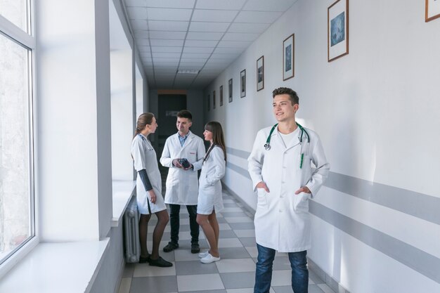 Cheerful medic standing in hallway