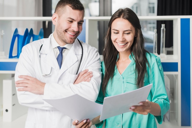 Cheerful medics standing with paper